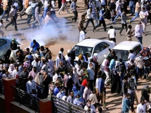 Sudanese demonstrators run from teargas lobbed to disperse them as they march along the street during anti-government protests in Khartoum, Sudan, on December 25, 2018. PHOTO | REUTERS